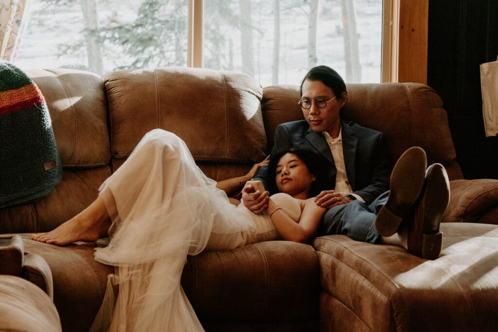 A newlywed couple enjoying a private moment in the mountain cabin they eloped in 
