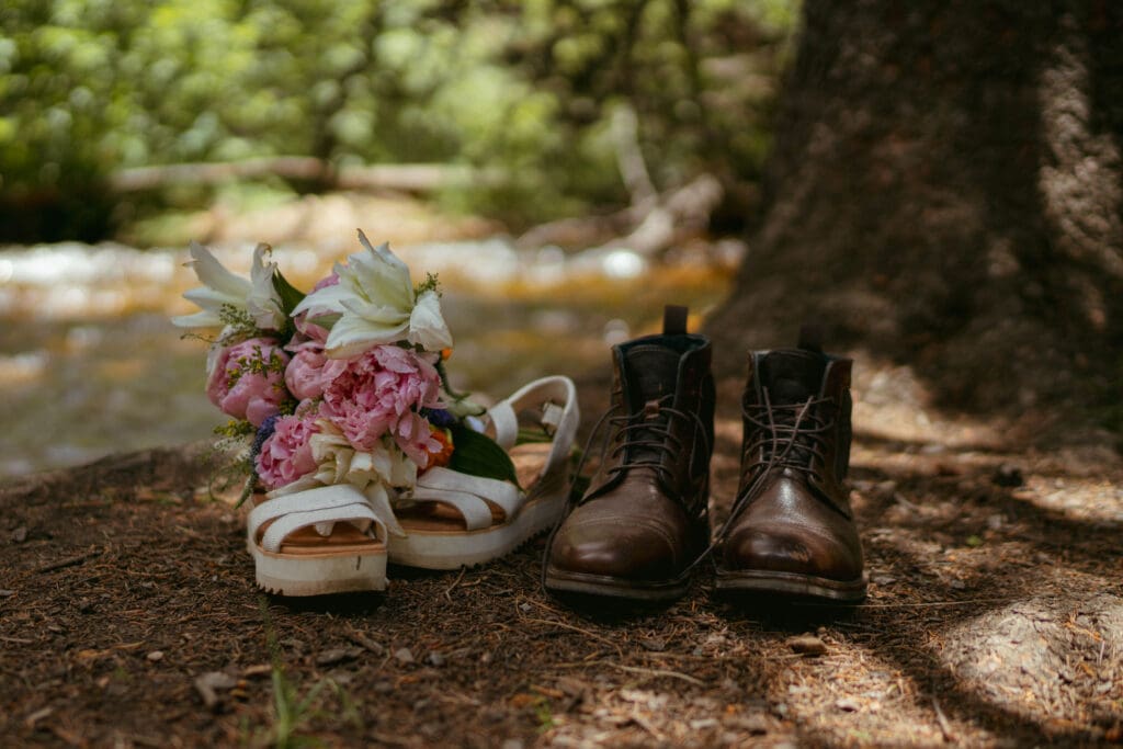 newlywed's shoes and bouquet styled on the ground in the woods of Rocky Mountain National Park